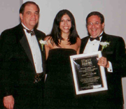Dr. Kristen M. Rezak (center) receiving award from Dr. John J. Ricotta (left) and Dr. Marc J. Shapiro (right).