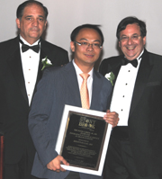 Dr. Kwannag Lau (center) receiving award from Dr. John J. Ricotta (left) and Dr. Marc J. Shapiro (right).