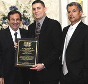 Dr. Michael Lieb (center) receiving award from  Dr. Marc J. Shapiro (left) and Dr. Todd K. Rosengart (right).