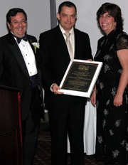 Dr. Alexandr Reznichenko (center) receiving award from Dr. Marc J. Shapiro and trauma nurse coordinator Jane E. McCormack, RN.